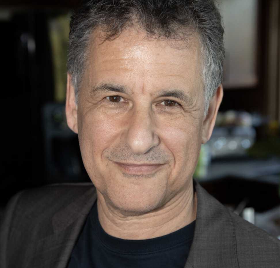 A portrait of Daniel J. Levitin, a person with short gray hair and a gray jacket.